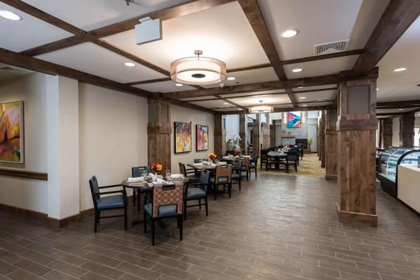 Interior view of a dining room with tables and artwork