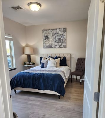 A well-appointed resident bedroom with floral decor