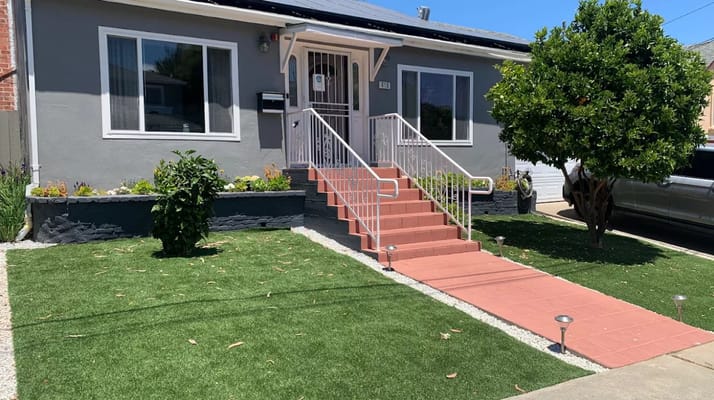 Front entrance with a ramp and landscaped pathway at Hearts at Millwood Assisted Living