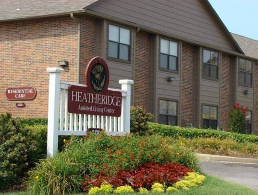 Sign for Heatheridge Assisted Living Center surrounded by colorful landscaping