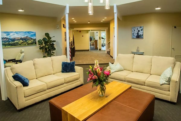 Interior common area with couches and flowers
