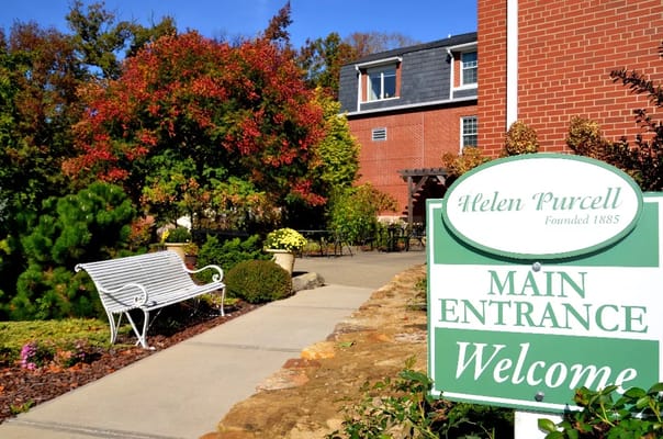 Sign and entrance area of Helen Purcell facility with gardens