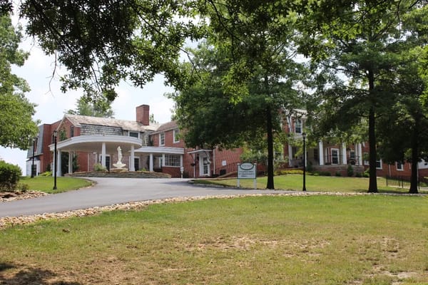 Exterior view of the facility with trees and walkway