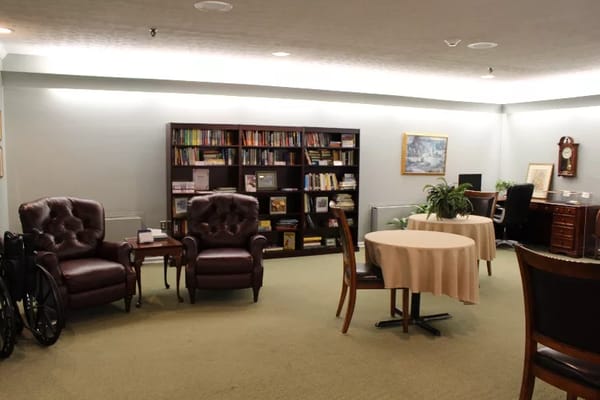 Comfortable common area with bookshelves and seating