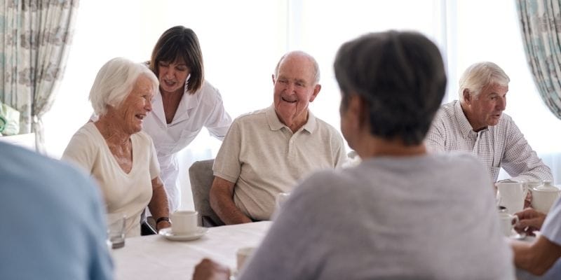 Residents enjoying a social gathering in a bright common area