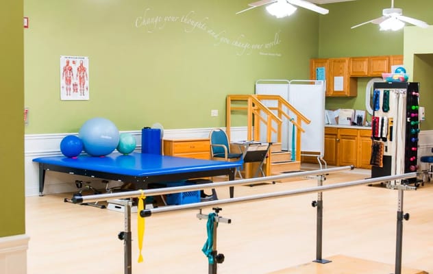 Empty therapy room with exercise equipment and stairs