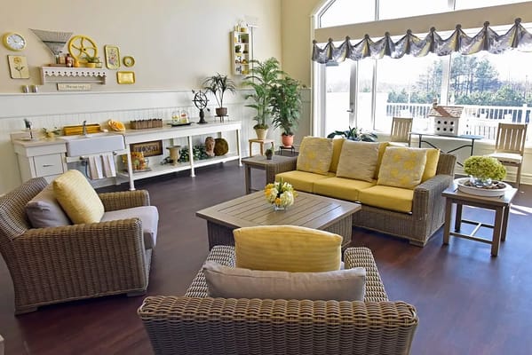 Bright and inviting living room with wicker furniture and large windows