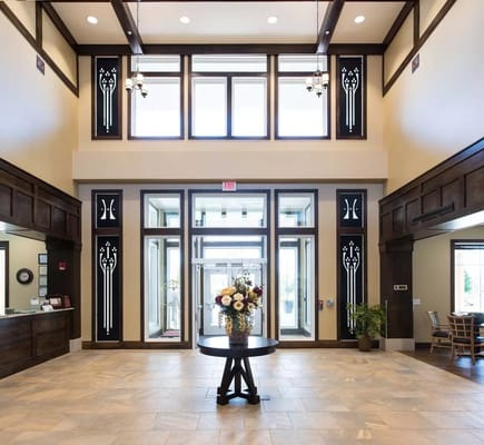 Bright and spacious lobby with a flower arrangement and reception area