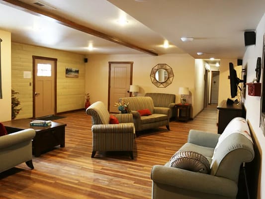 Bright common area with seating and wooden flooring