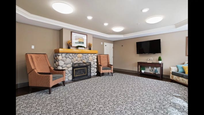 Cozy common area with chairs and a fireplace