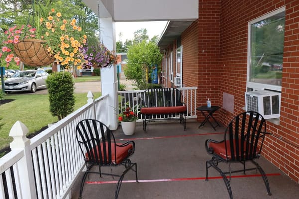 Outdoor seating area with flowers and benches