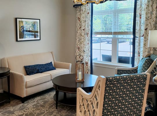 Bright living room with sofa and decorative chairs