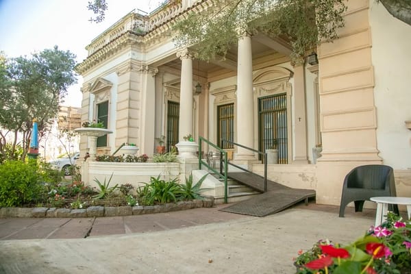 Accessible entrance with ramp and garden at Hogar San Francisco.