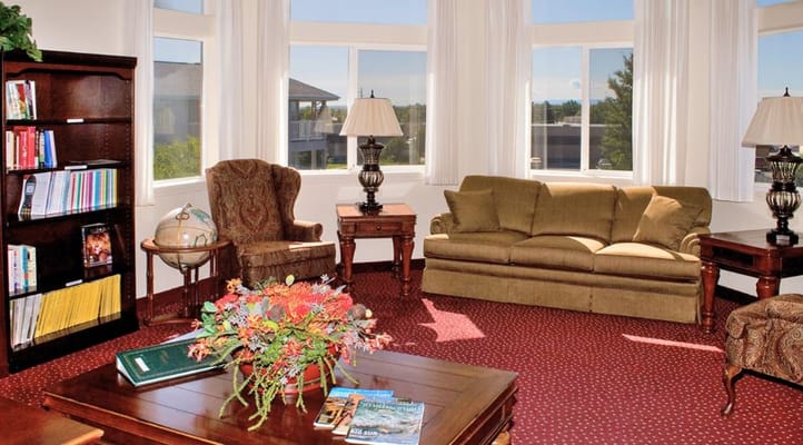 Inviting living room with a couch, chairs, and bookshelves