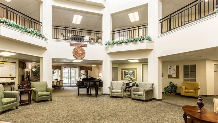 Spacious lobby with seating areas and a piano