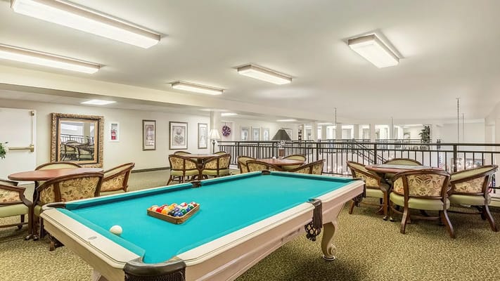 Billiards table with seating area in senior living community