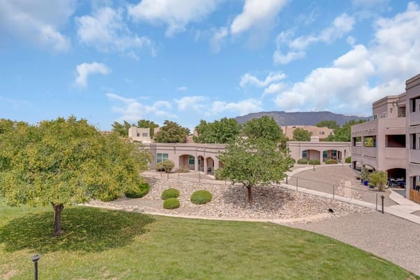 A landscaped outdoor area with benches and a garden