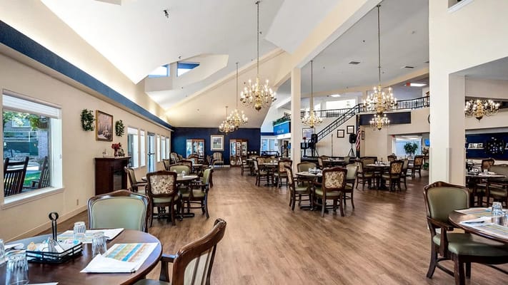 Elegant dining room area with chandeliers and tables