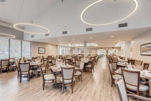 Bright dining room with tables set for meal service