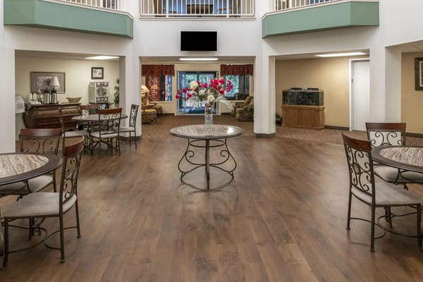 Spacious living area with tables and flower arrangement at Solista Hickory