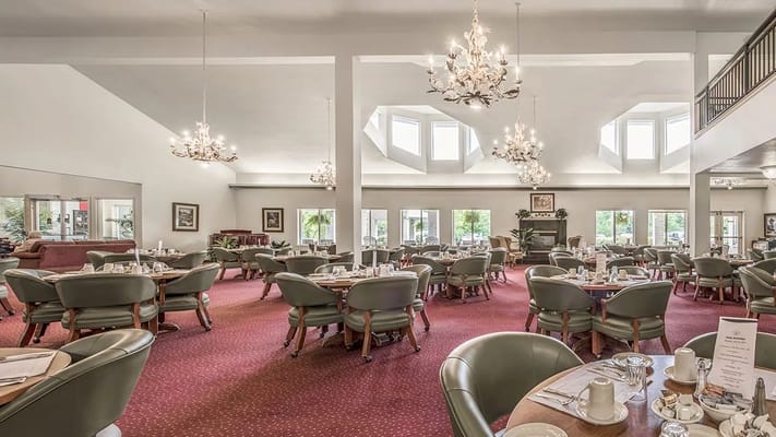 Bright dining room with large windows and elegant decor