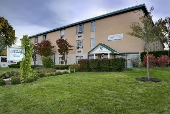 Front view of Holiday Retirement Community building with landscaped gardens