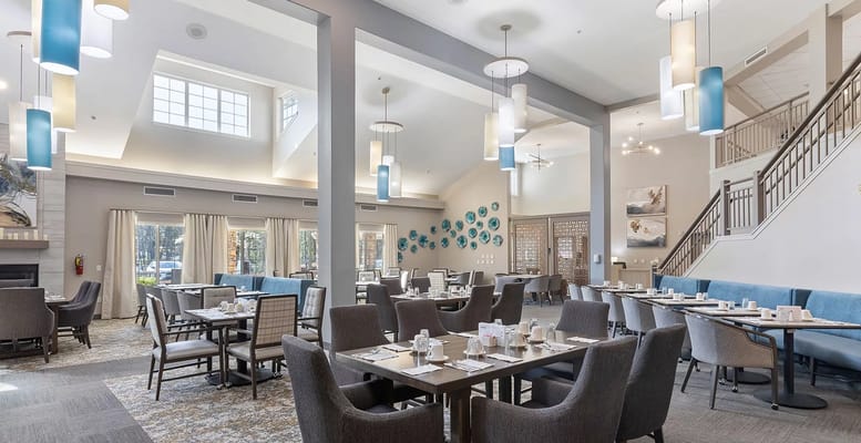 Bright dining room with tables set for a meal
