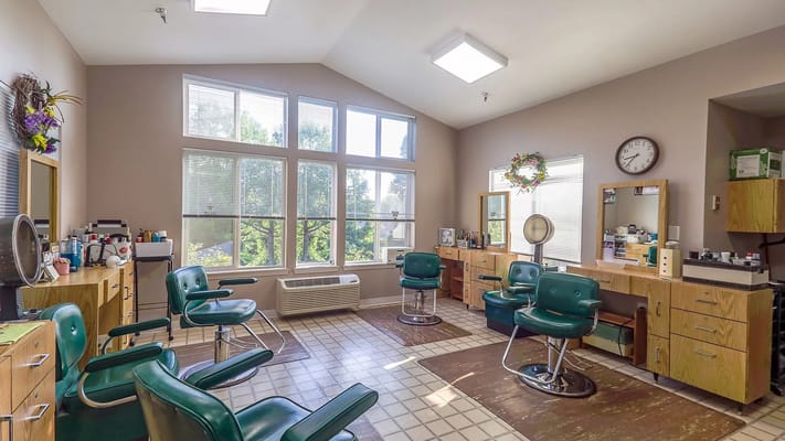 Bright salon area with styling chairs and mirrors