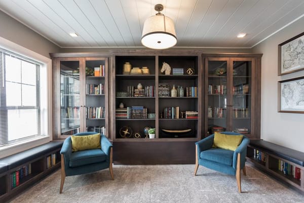 Comfortable seating area with bookshelves in Holland Farms library