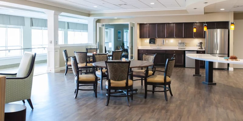 Cozy dining area with tables and chairs in a senior living facility
