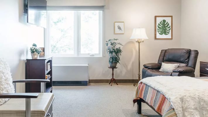 Cozy resident room with comfortable furniture and decor