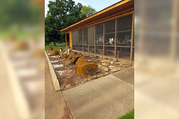 View of landscaping with rocks and pathway at Holy Cross Villas