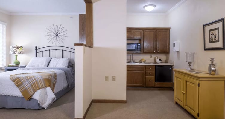 Private resident room with kitchenette and cozy decor