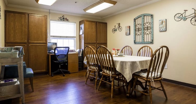 Bright common area with dining table and chairs