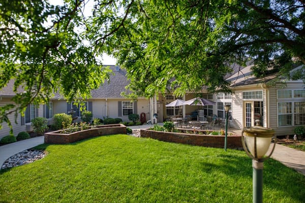 A sunlit outdoor space with seating areas and greenery