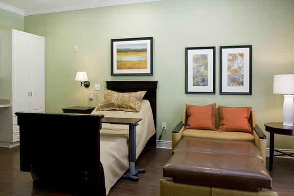 Cozy resident room with two beds and seating area