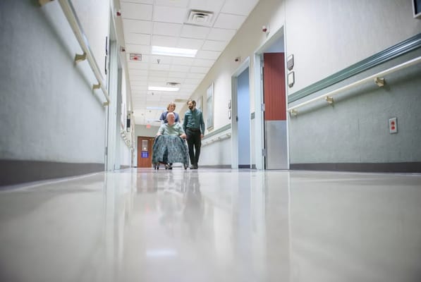 Staff assisting a resident in a hallway