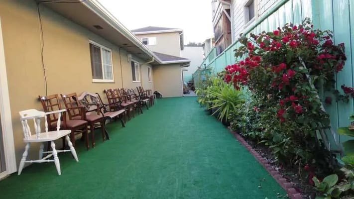 Outdoor walkway with chairs and flowers