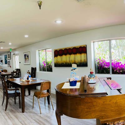 Interior view of a common area with a piano and art