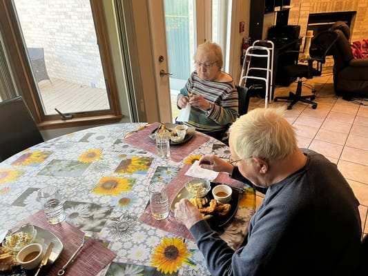 Residents enjoying a meal at a table