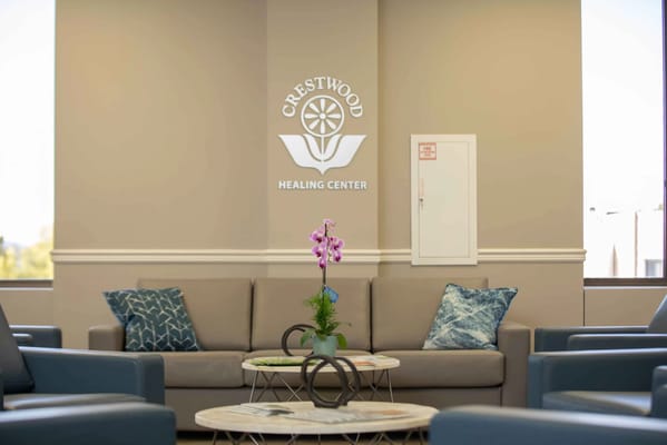 Interior view of a waiting area with orchids and seating