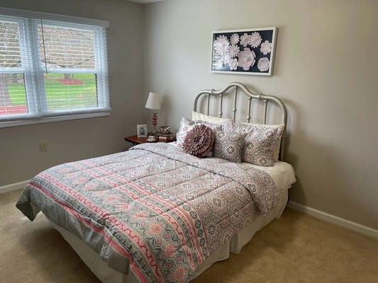 Cozy interior of a resident's bedroom with floral decor