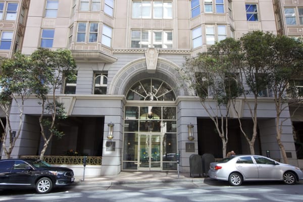 Exterior view of the entrance to San Francisco Towers, featuring decorative architecture.