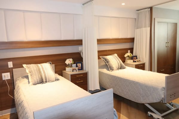 A bright, welcoming resident room with two beds