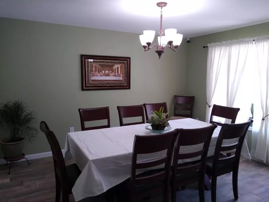 Dining area with a large table and seating.
