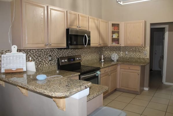 Spacious kitchen with granite countertops and modern appliances.