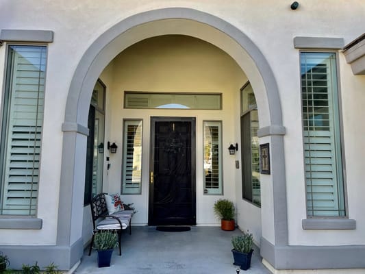 Entrance of a residential facility with decorative bench