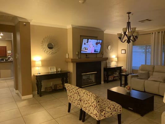 Bright common area with seating and a TV