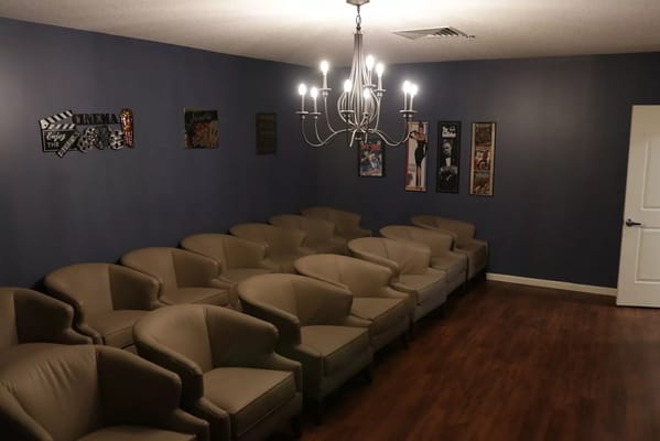 Interior of a cozy cinema room with comfortable seating