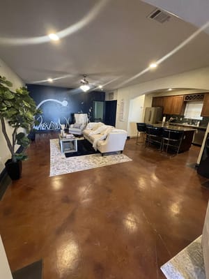 Comfortable living room with a couch, chairs, and a wall mural